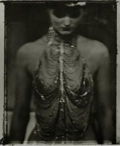 Sarah Moon's Photograph of a women with beads and crystals