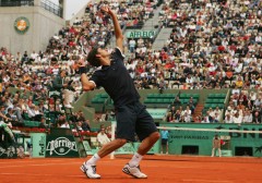 Roger Federer serving at Roland Garros French Open Tournament